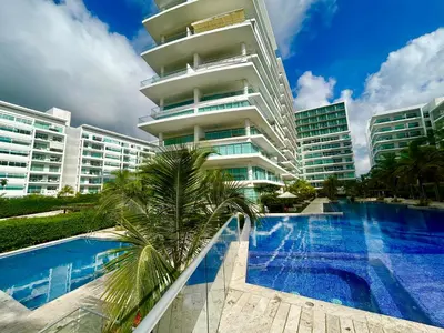 a hotel with a swimming pool in front of a building at Apartamento Cartagena in Cartagena de Indias