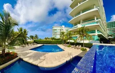 a resort with a swimming pool and a building at Apartamento Cartagena in Cartagena de Indias