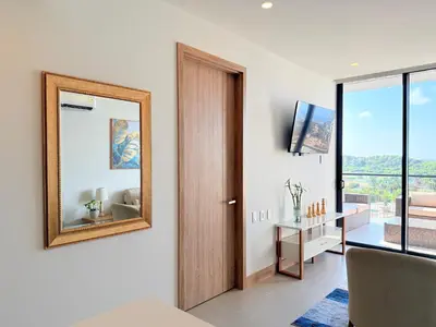 a living room with a mirror and a television at Premium Apartment - Beachfront - Luxury condo in Cartagena de Indias