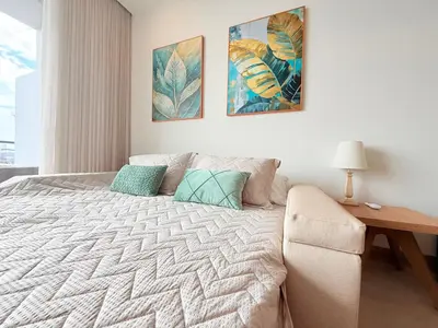 a bedroom with a large bed and a desk at Premium Apartment - Beachfront - Luxury condo in Cartagena de Indias