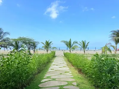 a path leading to a beach with palm trees at Premium Apartment - Beachfront - Luxury condo in Cartagena de Indias