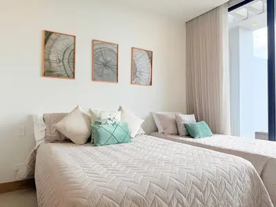a bedroom with two beds and a window at Premium Apartment - Beachfront - Luxury condo in Cartagena de Indias