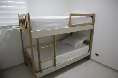 a couple of bunk beds in a room at Cartagena Piscina, playa y cerca centro Historico in Cartagena de Indias