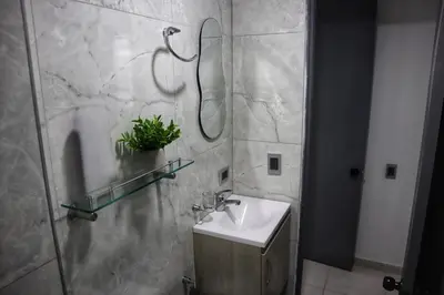 a bathroom with a sink and a shower at Cartagena Piscina, playa y cerca centro Historico in Cartagena de Indias