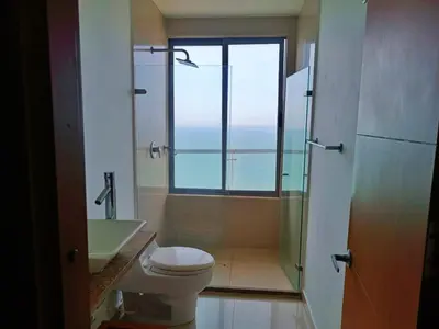 a bathroom with a toilet and a shower and a window at Sky Ocean View in Cartagena de Indias