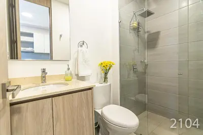 a bathroom with a toilet and a sink and a shower at Santa Marina Apartments and Beach Club by Xarm Apartments in Santa Marta