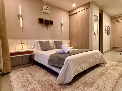 a bedroom with a large bed in a room at Santa Marina Apartments and Beach Club by Xarm Apartments in Santa Marta
