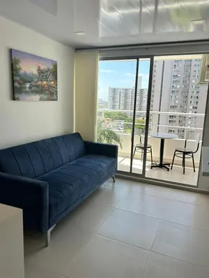 a living room with a blue couch and a large window at Entire apartment with amazing views Tower 811 in Cartagena de Indias