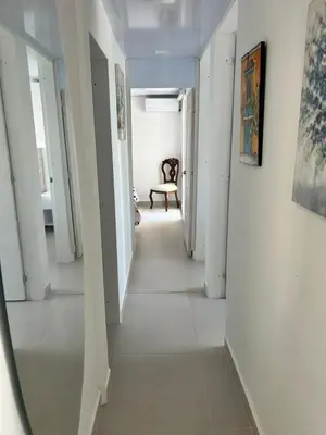 a long hallway with white walls and white floors at Entire apartment with amazing views Tower 811 in Cartagena de Indias