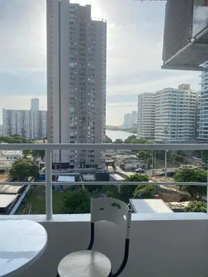 a balcony with a table and chairs and a view of a city at Entire apartment with amazing views Tower 811 in Cartagena de Indias