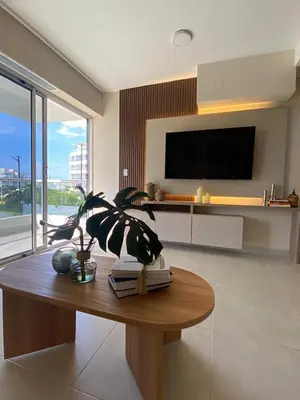 a living room with a table with a plant on it at Pool , Private Beach Modern and Serene Apartment in Serena del Mar