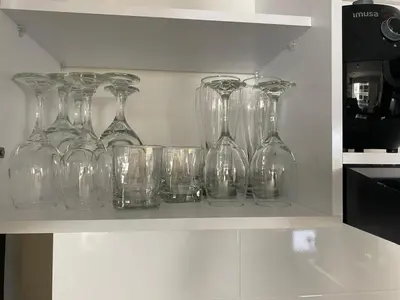 a row of glass vases sitting on a shelf at Pool , Private Beach Modern and Serene Apartment in Serena del Mar