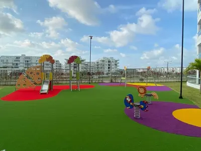 a playground in a city with a play area at Pool , Private Beach Modern and Serene Apartment in Serena del Mar