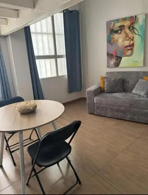 a living room with a table and a couch at Exclusive Studio Apartment in the Old City Cartagena in Cartagena de Indias