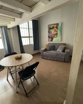 a living room with a table and a couch at Exclusive Studio Apartment in the Old City Cartagena in Cartagena de Indias