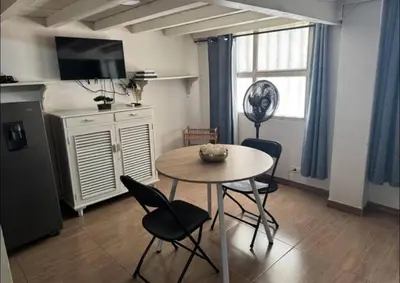 a kitchen with a table and chairs in a room at Exclusive Studio Apartment in the Old City Cartagena in Cartagena de Indias