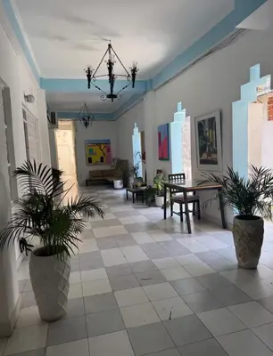 a large room with potted plants on a tile floor at Exclusive Studio Apartment in the Old City Cartagena in Cartagena de Indias