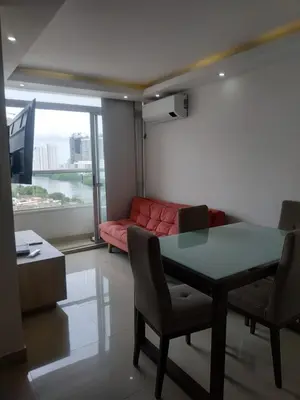 a living room with a table and a red couch at Cartagenafantastica in Cartagena de Indias