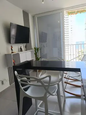 a dining room with a glass table and two chairs at Apartamento en Cartagena amoblado con vista al mar in Cartagena de Indias