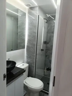 a bathroom with a toilet and a glass shower at Apartamento en Cartagena amoblado con vista al mar in Cartagena de Indias
