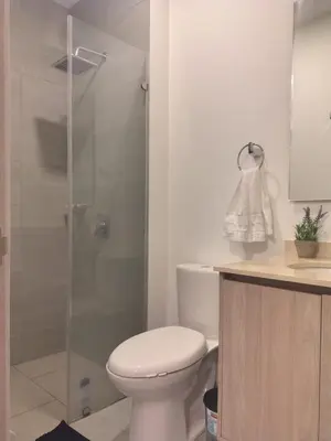 a white bathroom with a toilet and a shower at Santa Marina Santa Marta - By INMOBILIARIA VS in Santa Marta
