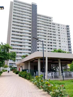 a large building with tables and chairs in front of it at Santa Marina Santa Marta - By INMOBILIARIA VS in Santa Marta