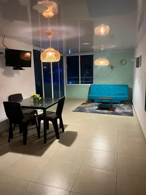 a living room with a table and a blue couch at Vacaciones en el Caribe - Laguito Cartagena al lado de bocagrande in Cartagena de Indias