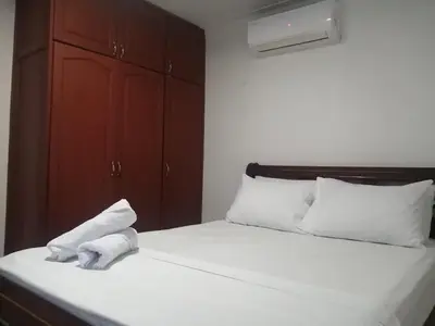 a bed with a pile of white towels on it at Cómodo APTO En El Laguito las 3 Carabelas in Cartagena de Indias