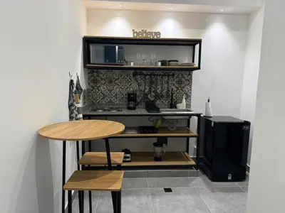 a room with a table and a television and a table and stool at Living Sincelejo in Sincelejo