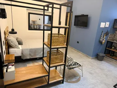 a room with a room with a bed and a shelf at Living Sincelejo in Sincelejo
