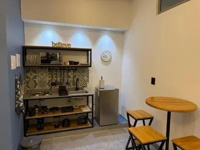 a room with a counter and a table and a refrigerator at Living Sincelejo in Sincelejo