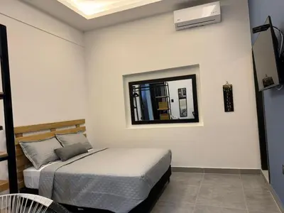 a bedroom with a bed and a mirror on the wall at Living Sincelejo in Sincelejo