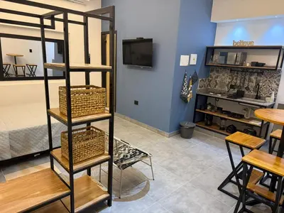 a living room with a shelf with baskets on it at Living Sincelejo in Sincelejo