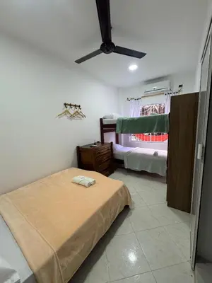 a bedroom with a bed and a ceiling fan at Hotel Casa Colonial Moñitos in Moñitos
