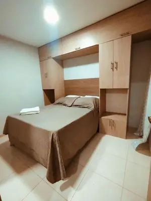 a bedroom with a large bed and wooden cabinets at Exclusivo Torices con Vista al Mar in Arizona