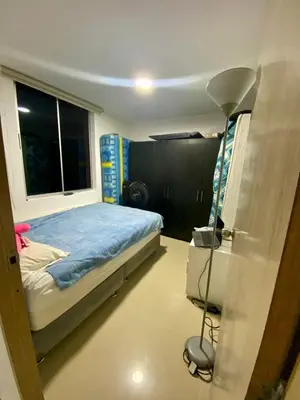 a bedroom with a bed and a lamp in it at Apartamento en villa campestre Barranquilla in Barranquilla