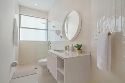 a white bathroom with a sink and a mirror at Luxury a 100 Mts del Mar en Edificio SeaWay in Cartagena de Indias