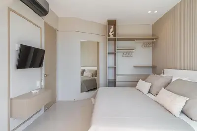 a bedroom with a white bed and a television at Luxury a 100 Mts del Mar en Edificio SeaWay in Cartagena de Indias