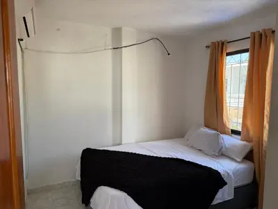 a small bedroom with a bed with a window at Apto emperatriz house in Cartagena de Indias