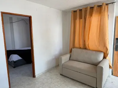 a mirror in a room with a chair and a mirror at Emperatriz I in Cartagena de Indias