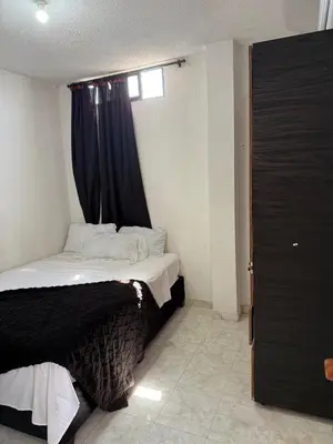 a bedroom with a bed with a black curtain at Emperatriz I in Cartagena de Indias