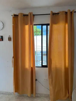 an orange curtain in a room with a window at Emperatriz I in Cartagena de Indias