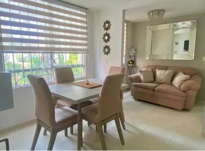 a living room with a table and chairs and a couch at La mejor ubicación al norte de Barranquilla in Barranquilla