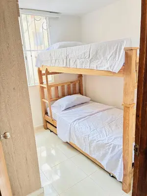 a bedroom with two bunk beds and a window at La mejor ubicación al norte de Barranquilla in Barranquilla