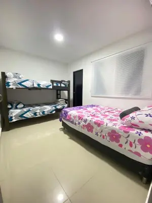 a bedroom with a bed and two bunk beds at Apartamento BBB para 4 pax en La Boquilla in Cartagena de Indias