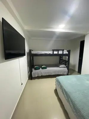 a bedroom with a bed and a flat screen tv at Cómodo & Económico Apartamento en La boquilla BBB 4 pax in Cartagena de Indias