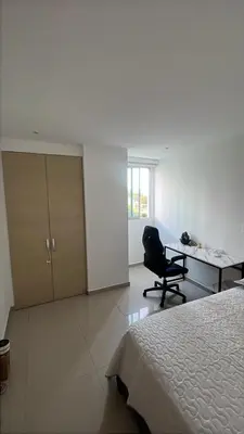 a bedroom with a bed and a desk and a chair at Apartamento en Cartagena Marbella in Cartagena de Indias