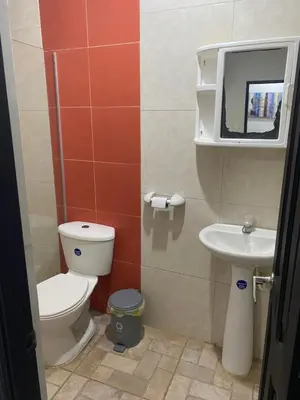 a bathroom with a toilet and a sink at Hotel Nellamar in Puerto Colombia