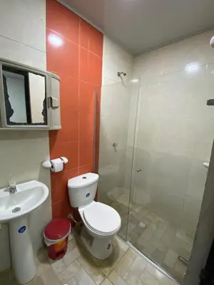 a bathroom with a shower and a toilet and a sink at Hotel Nellamar in Puerto Colombia