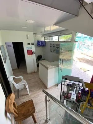 a room with a glass table and a chair at Hotel Nellamar in Puerto Colombia